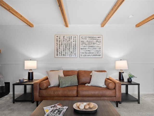 living room with carpet and beamed ceiling