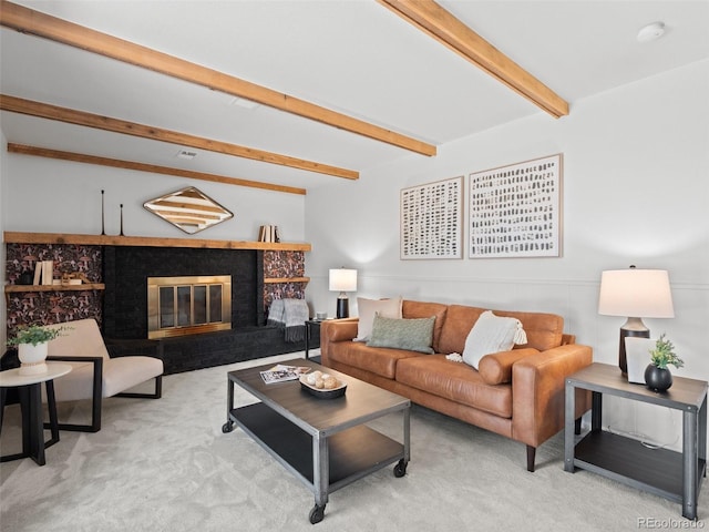 living area with carpet floors, a brick fireplace, and beam ceiling