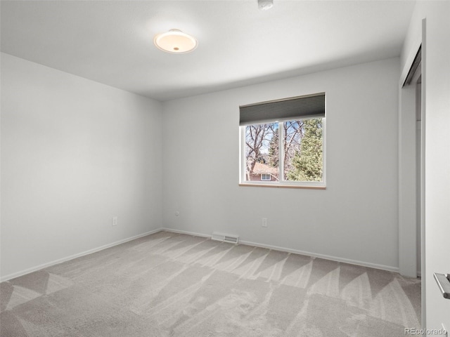 unfurnished bedroom with baseboards, visible vents, and light colored carpet