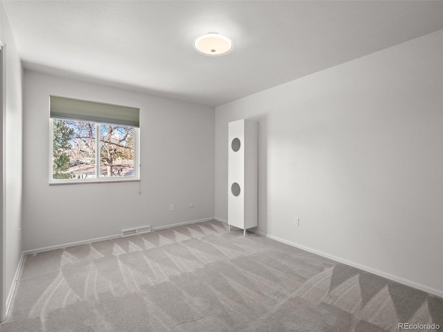 unfurnished bedroom with carpet, visible vents, and baseboards