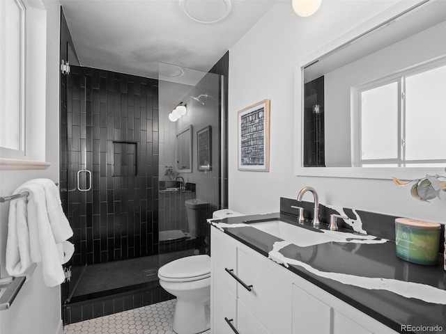 bathroom with toilet, a stall shower, vanity, and tile patterned floors