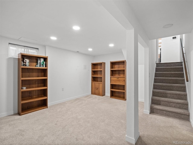 finished basement with carpet floors, baseboards, stairway, and recessed lighting