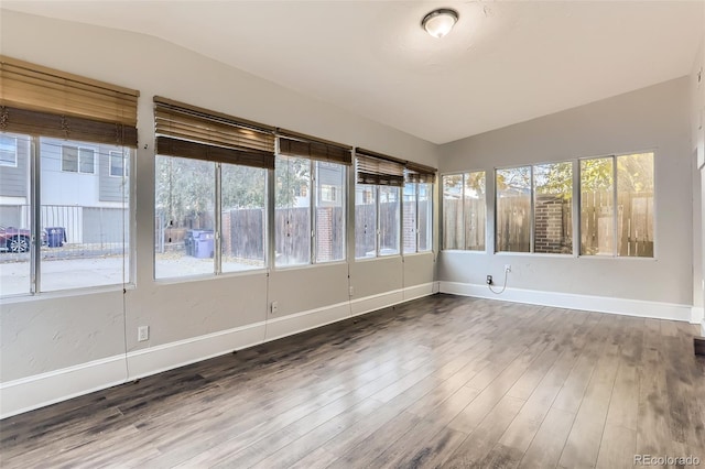 unfurnished sunroom featuring vaulted ceiling