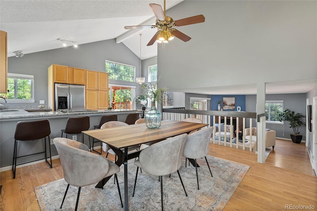19937 E Loyola Pl, Aurora, CO 80013 - dining area with light wood-style floors, a ceiling fan, healthy amount of natural light, beamed ceiling, and high vaulted ceiling