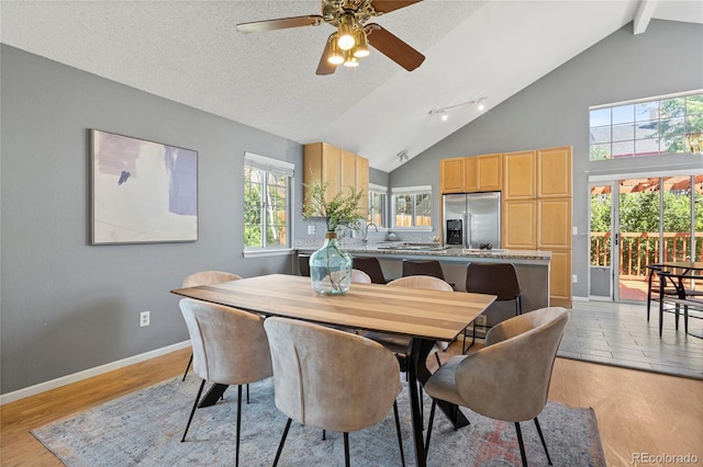19937 E Loyola Pl, Aurora, CO 80013 - dining room with a ceiling fan, high vaulted ceiling, beam ceiling, and light wood-style floors