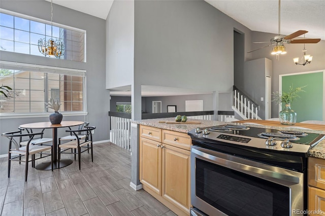 19937 E Loyola Pl, Aurora, CO 80013 - kitchen featuring stainless steel range with electric cooktop, light brown cabinets, high vaulted ceiling, a chandelier, and ceiling fan