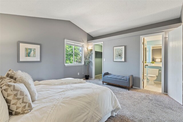 19937 E Loyola Pl, Aurora, CO 80013 - carpeted bedroom featuring vaulted ceiling, a walk in closet, ensuite bathroom, and a closet
