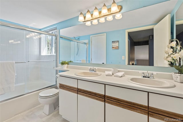 19937 E Loyola Pl, Aurora, CO 80013 - bathroom with double vanity and bath / shower combo with glass door