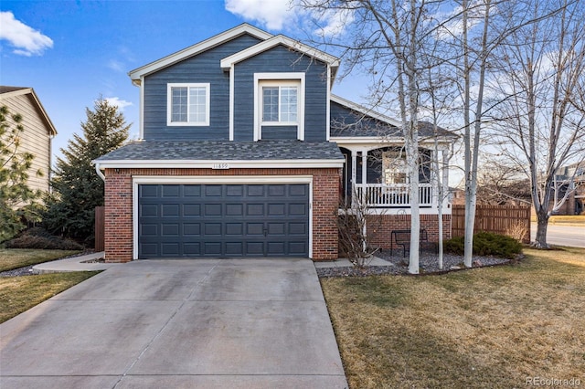 tri-level home with brick siding, a porch, a garage, driveway, and a front lawn