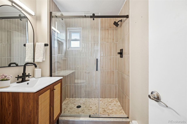 bathroom featuring a shower stall and vanity