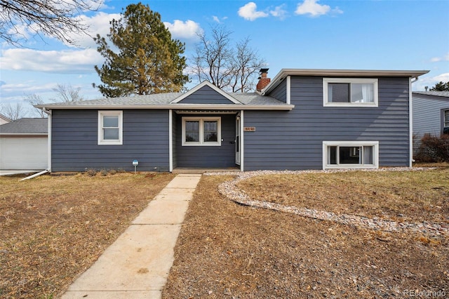 tri-level home with a chimney