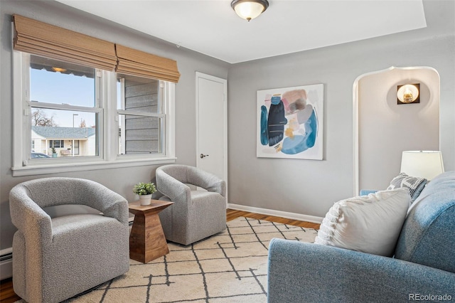 living area with light wood-style flooring and baseboards