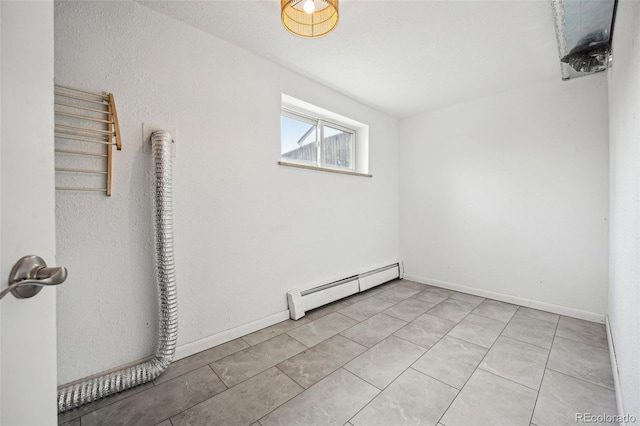 unfurnished room with a baseboard radiator and baseboards