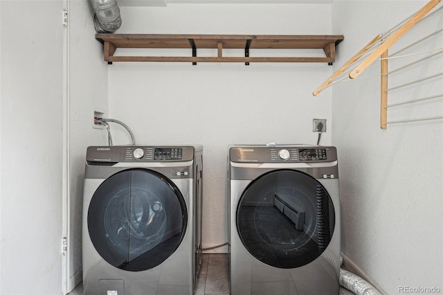 clothes washing area featuring laundry area, independent washer and dryer, and tile patterned flooring