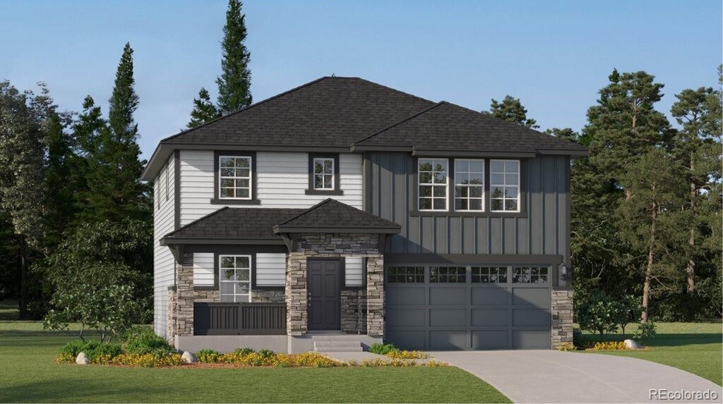 view of front of property with a garage and a front lawn