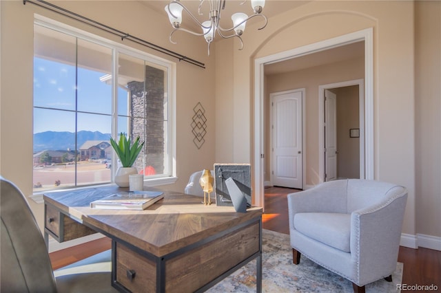 dining space with a mountain view, hardwood / wood-style flooring, and a chandelier