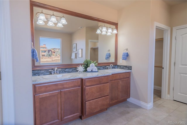 bathroom with tasteful backsplash, tile patterned floors, and vanity