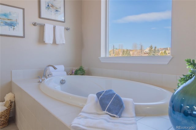 bathroom featuring tiled bath and plenty of natural light