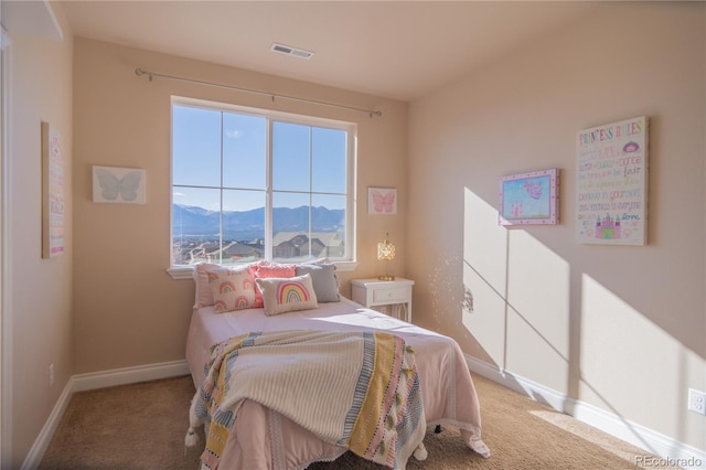 bedroom with a mountain view and carpet floors