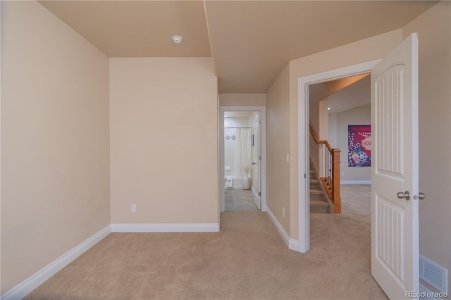 interior space featuring light carpet