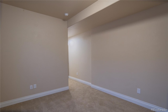 unfurnished room featuring light colored carpet