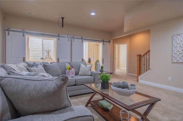 carpeted living room featuring a barn door