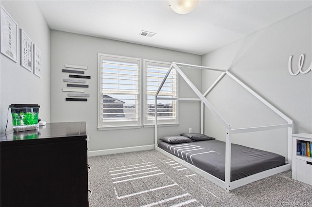 carpeted bedroom featuring baseboards and visible vents