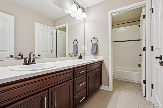 bathroom featuring double vanity, tile patterned flooring, a sink, and toilet