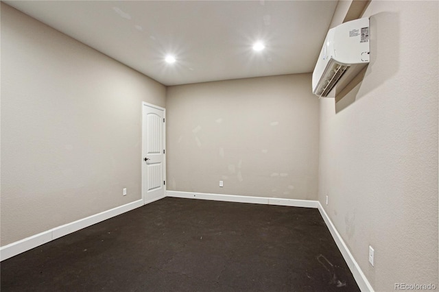 spare room featuring recessed lighting, an AC wall unit, and baseboards