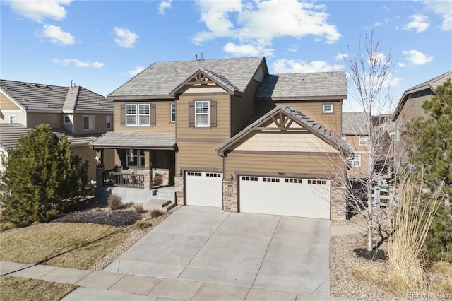 craftsman-style home with a porch, concrete driveway, an attached garage, and stone siding