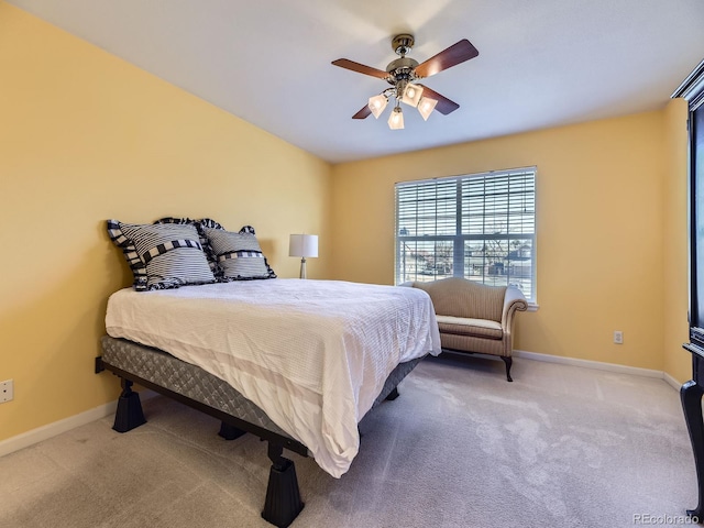 carpeted bedroom with ceiling fan and baseboards