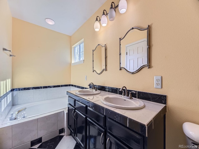 bathroom with toilet, double vanity, a sink, and a bath