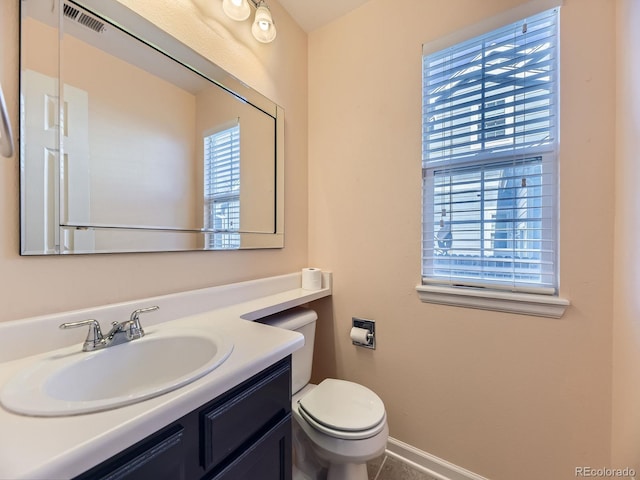 bathroom with visible vents, baseboards, toilet, tile patterned flooring, and vanity