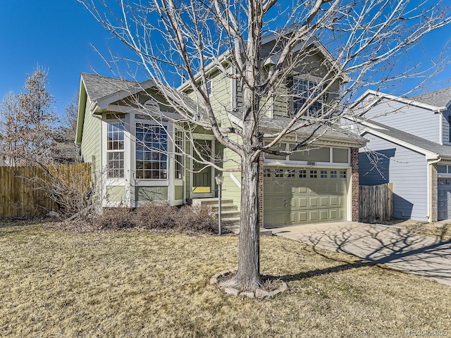 traditional home featuring driveway, a garage, fence, and brick siding