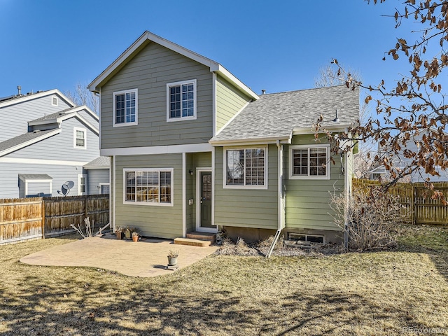 rear view of property featuring a shingled roof, a lawn, entry steps, a patio area, and fence