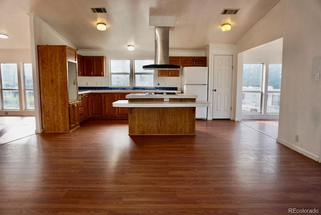 kitchen featuring dark hardwood / wood-style flooring, a wealth of natural light, a center island, and island range hood