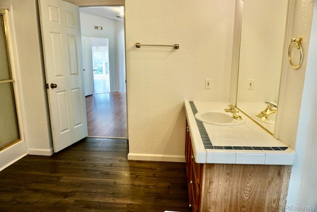 bathroom with an enclosed shower, hardwood / wood-style flooring, and vanity