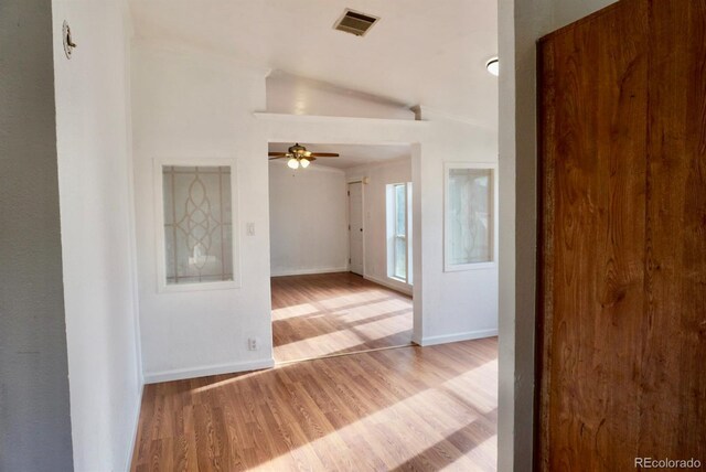 interior space with lofted ceiling and light hardwood / wood-style flooring