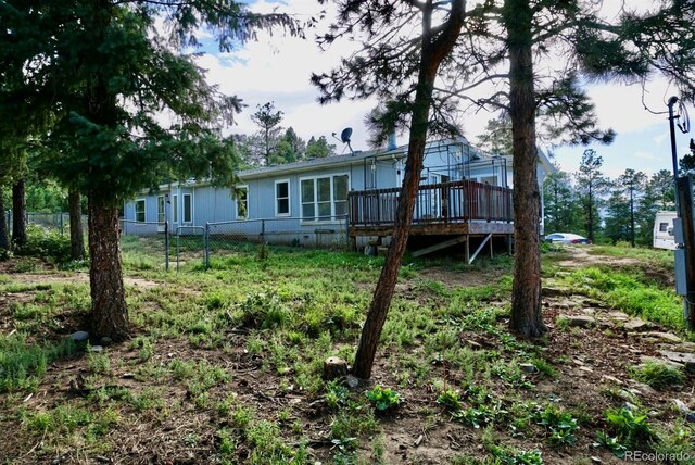 back of house with a wooden deck