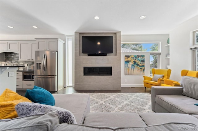 2564 S Carey Way, Denver, CO 80222 - living room featuring recessed lighting, dark wood finished floors, a fireplace, and baseboards