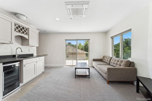 2564 S Carey Way, Denver, CO 80222 - living area featuring wine cooler, plenty of natural light, wet bar, and light tile patterned floors
