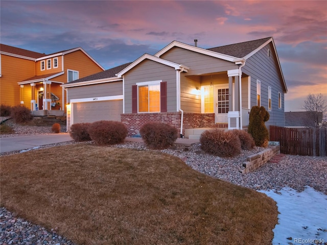 ranch-style home featuring a garage and a yard