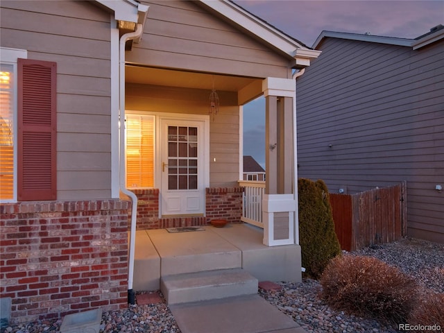 view of exterior entry at dusk