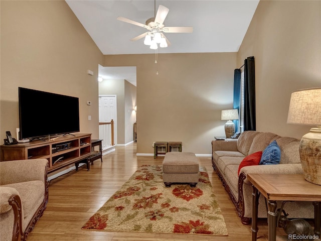 living room featuring ceiling fan, high vaulted ceiling, and light hardwood / wood-style floors