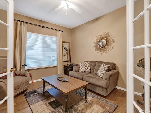 living room featuring hardwood / wood-style flooring, french doors, and ceiling fan