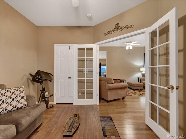 living room with hardwood / wood-style floors, french doors, and ceiling fan