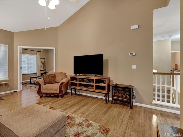 living room with hardwood / wood-style flooring, lofted ceiling, and ceiling fan