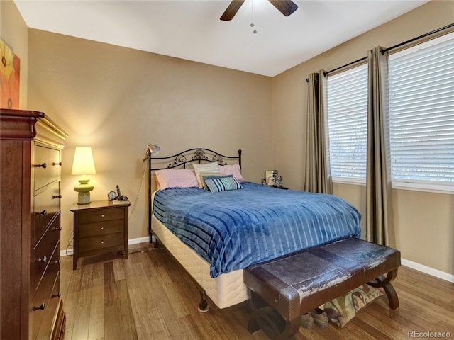 bedroom with ceiling fan and hardwood / wood-style floors