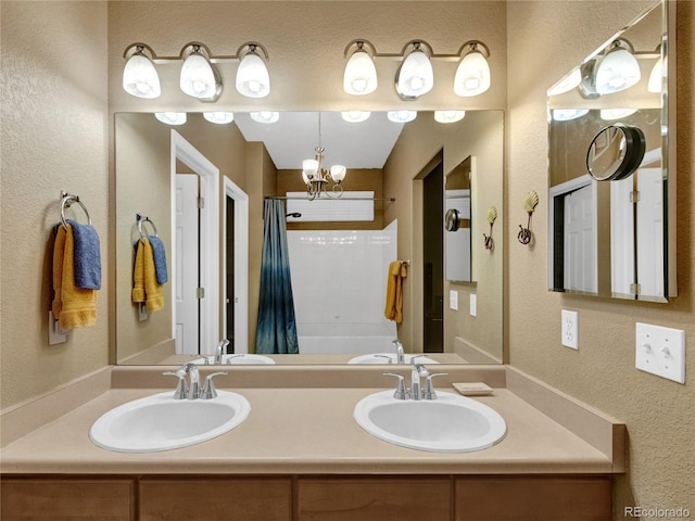 bathroom featuring shower / tub combo, vanity, and a notable chandelier