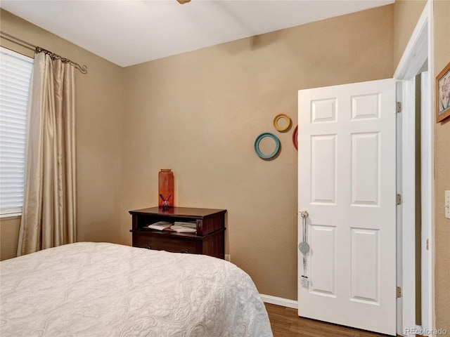 bedroom featuring wood-type flooring and ceiling fan